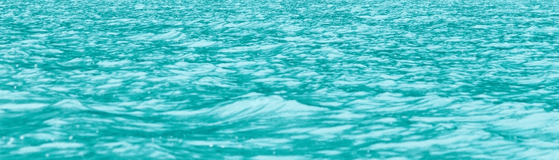 A serene surface of turquoise water with gentle waves.