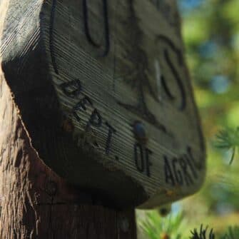 Close-up of a weathered wooden sign with the words "Dept. of Agri." visible.