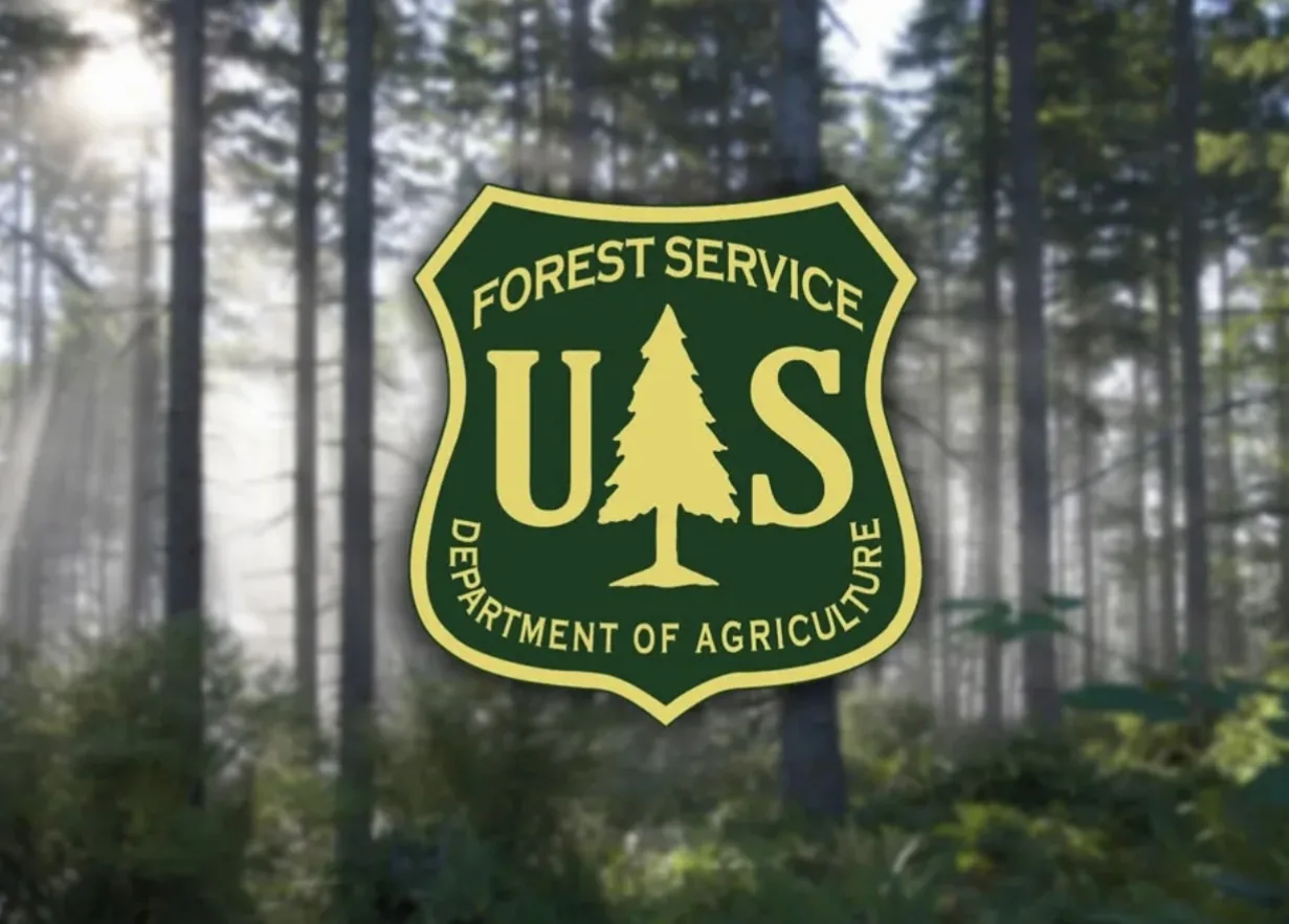 Logo of the U.S. Forest Service, featuring a stylized tree and text on a forest background.